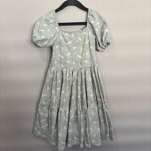 Alice + Ames light green tiered dress with cream rabbits and carrots